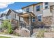 Charming home with a stone facade, inviting front porch, and well-maintained landscaping creates great curb appeal at 21761 E 7Th Ave, Aurora, CO 80018