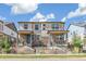 Modern townhouse exterior with stone accents, covered porch, and well-maintained landscaping at 21761 E 7Th Ave, Aurora, CO 80018