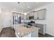 Open kitchen featuring gray cabinetry, stainless steel appliances, and granite island at 21761 E 7Th Ave, Aurora, CO 80018