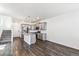 Bright open-concept kitchen with gray cabinets, island, stainless steel appliances, and wood flooring at 21761 E 7Th Ave, Aurora, CO 80018