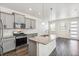 Modern kitchen with gray cabinets, stainless steel appliances, granite countertops, and island at 21761 E 7Th Ave, Aurora, CO 80018