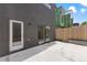 Modern home with concrete backyard patio, sliding glass doors, and wood fence at 3711 Pecos St, Denver, CO 80211