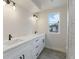 Modern bathroom featuring double sinks, white cabinetry, and stylish fixtures at 3711 Pecos St, Denver, CO 80211
