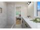 Elegant bathroom with white vanity, marble shower, and view of a bedroom at 3711 Pecos St, Denver, CO 80211