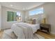 Cozy bedroom with neutral tones, plush bedding, and ample natural light from large windows at 3711 Pecos St, Denver, CO 80211