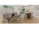 Dining area connected to the living room, showcasing hardwood floors and stylish furniture at 3711 Pecos St, Denver, CO 80211