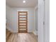 Bright entryway with a modern front door and hardwood floors, leading to the staircase at 3711 Pecos St, Denver, CO 80211