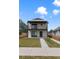 Modern two-story home featuring a white brick facade, balconies, and a well-maintained lawn at 3711 Pecos St, Denver, CO 80211