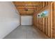 Spacious unfinished garage featuring a concrete floor, overhead door, and a window for natural light at 3711 Pecos St, Denver, CO 80211
