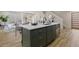 Open-concept kitchen featuring a large island with modern fixtures and adjacent living space at 3711 Pecos St, Denver, CO 80211