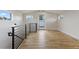 Bright living room with hardwood floors, steel railing, and lots of sunlight at 3711 Pecos St, Denver, CO 80211