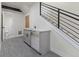 Basement wet bar and stairs with stainless steel dishwasher and gray cabinets at 3711 Pecos St, Denver, CO 80211
