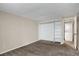 A clean, carpeted bedroom with built-in closet storage and laundry access at 2485 S Xanadu Way # D, Aurora, CO 80014
