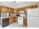 A functional kitchen featuring classic wooden cabinets and essential appliances at 2485 S Xanadu Way # D, Aurora, CO 80014