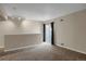 The living room has neutral walls, carpet, and a sliding glass door that provides access to the outdoors at 2485 S Xanadu Way # D, Aurora, CO 80014