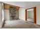 Inviting living room featuring a stone fireplace and wood beamed ceiling at 2485 S Xanadu Way # D, Aurora, CO 80014