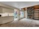 Open living room with fireplace, adjacent to a kitchen and sliding glass door at 2485 S Xanadu Way # D, Aurora, CO 80014