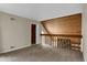 The loft offers a unique space with wooden wall accents and a cozy, carpeted floor at 2485 S Xanadu Way # D, Aurora, CO 80014
