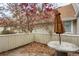 Private patio featuring a charming tree in bloom and a seating area at 2485 S Xanadu Way # D, Aurora, CO 80014