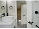 Modern bathroom with a round sink, black matte fixtures, and marble vanity at 6148 Nelson St, Arvada, CO 80004