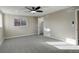 Bright bedroom with ceiling fan, closet, and ample natural light at 6148 Nelson St, Arvada, CO 80004