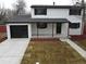 Remodeled two-story home with a modern exterior and landscaped front yard at 6148 Nelson St, Arvada, CO 80004