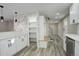 Modern kitchen featuring white cabinets, quartz countertops, and hexagon backsplash at 6148 Nelson St, Arvada, CO 80004