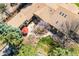 A beautiful aerial view of a home's backyard with a patio, outdoor seating, landscaping, and mature trees at 10395 W 74Th Pl, Arvada, CO 80005