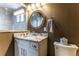 Well-lit bathroom featuring marble countertops and vanity at 10395 W 74Th Pl, Arvada, CO 80005