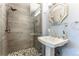 Modern bathroom featuring sleek, glass-enclosed walk-in shower and pedestal sink at 10395 W 74Th Pl, Arvada, CO 80005