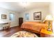 Comfortable bedroom with hardwood floors, a decorative rug, a desk and chair, and bright natural light at 10395 W 74Th Pl, Arvada, CO 80005