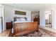 Comfortable bedroom with hardwood floors, large bed, and ample natural light from the windows at 10395 W 74Th Pl, Arvada, CO 80005