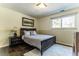 Comfortable bedroom featuring a full-sized bed, neutral decor, and natural light at 10395 W 74Th Pl, Arvada, CO 80005