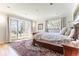 Bright bedroom with french doors, a cozy bed, and a serene atmosphere at 10395 W 74Th Pl, Arvada, CO 80005