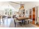Open-concept design featuring a large dining table flowing seamlessly into the living room, perfect for entertaining at 10395 W 74Th Pl, Arvada, CO 80005