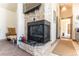 Stone fireplace with black accents in recreation room at 10395 W 74Th Pl, Arvada, CO 80005