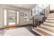 Bright foyer with modern staircase, large windows, and stylish tile flooring at 10395 W 74Th Pl, Arvada, CO 80005