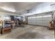 Spacious two-car garage with an automatic door, storage area, and ample room for vehicles at 10395 W 74Th Pl, Arvada, CO 80005