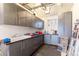 Well-organized garage with gray cabinets, utility sink, and plenty of storage space for tools and equipment at 10395 W 74Th Pl, Arvada, CO 80005