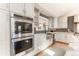 Beautiful kitchen with stainless steel appliances, modern cabinetry, and stylish backsplash at 10395 W 74Th Pl, Arvada, CO 80005