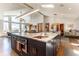 Spacious open kitchen with a large island, modern appliances, and plenty of natural light at 10395 W 74Th Pl, Arvada, CO 80005