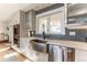 Lovely kitchen with stainless steel appliances, modern cabinetry, designer backsplash, and farmhouse sink at 10395 W 74Th Pl, Arvada, CO 80005
