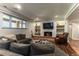 Cozy living room with fireplace, built-in shelving, and comfortable seating at 10395 W 74Th Pl, Arvada, CO 80005