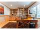 Cozy home office with custom built-ins, a large wooden desk, and natural light at 10395 W 74Th Pl, Arvada, CO 80005