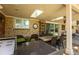 Covered outdoor patio with a built-in grill, comfortable seating, and a skylight providing ample natural light at 10395 W 74Th Pl, Arvada, CO 80005
