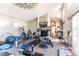 Open concept recreation space with fireplace and multiple windows at 10395 W 74Th Pl, Arvada, CO 80005