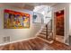 Unique staircase with modern railing and a wine cellar visible through the doorway at 10395 W 74Th Pl, Arvada, CO 80005