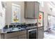 Stylish wet bar featuring granite countertops, stainless steel appliances, and a convenient sink at 10395 W 74Th Pl, Arvada, CO 80005