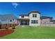 Expansive backyard with green grass, wood fence, and a patio, perfect for outdoor enjoyment at 13446 Amber Sky St, Parker, CO 80134