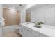 Well-lit bathroom with a shower-tub combo and white vanity with dark hardware at 13446 Amber Sky St, Parker, CO 80134